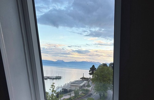 Evian-les-Bains Apartment | Charming little studio with lake and mountain views from the bed.