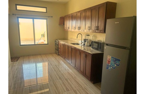 Salt Gut Apartment | Minimalist queen suite with soothing décor and ensuite bathroom for quiet reflection.