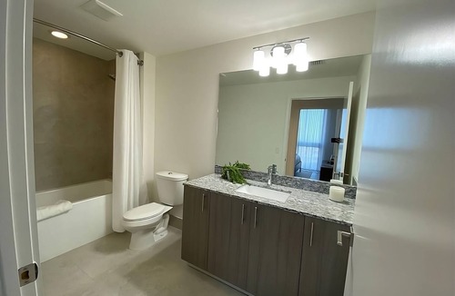 Doral Hotel | Modern 3BR City View Residence with Balcony and Luxury Amenities Near Downtown