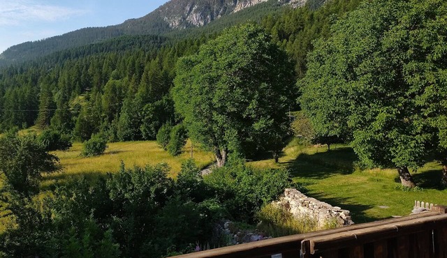 A large house in a remote mountain hamlet surrounded by nature